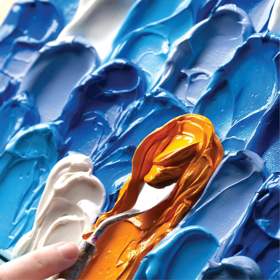 Raised blue acrylic paint with a palette knife and contrasting paint colors